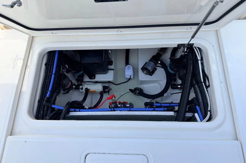 Slide: The Image of 2022 Boston Whaler 250 Outrage boat compartment with wiring and components visible. - 25