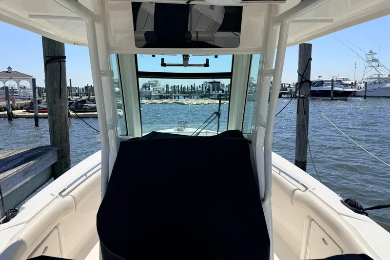 Slide: The Image of 2022 Boston Whaler 250 Outrage boat docked at marina, interior view. - 26