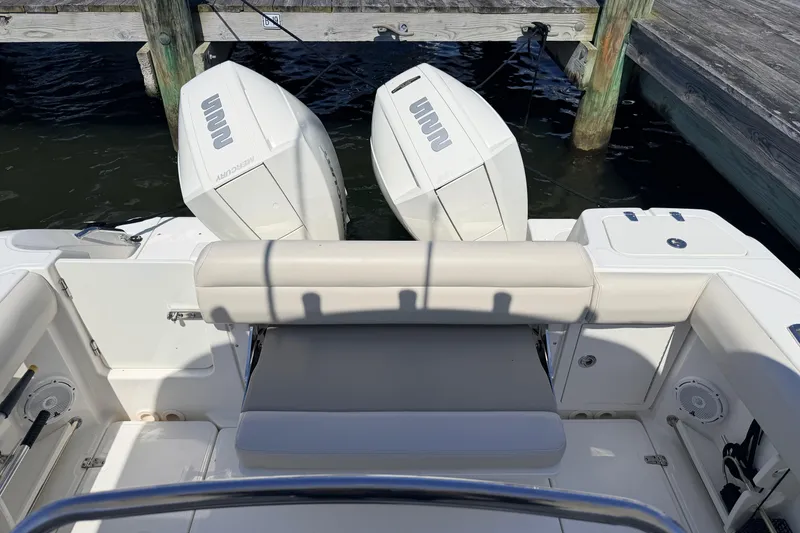 Slide: The Image of 2022 Boston Whaler 250 Outrage boat with dual Mercury engines at dock. - 28