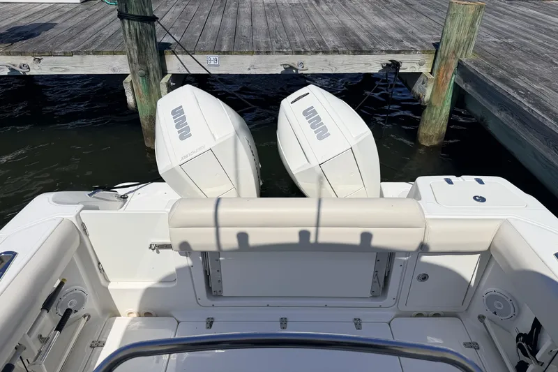 Slide: The Image of 2022 Boston Whaler 250 Outrage boat with dual engines docked at a marina. - 29