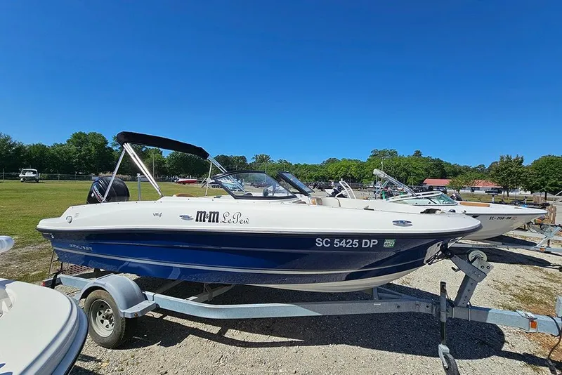 The Image of 2021 Bayliner VR4 Bowrider OB on trailer under clear blue sky. - 1
