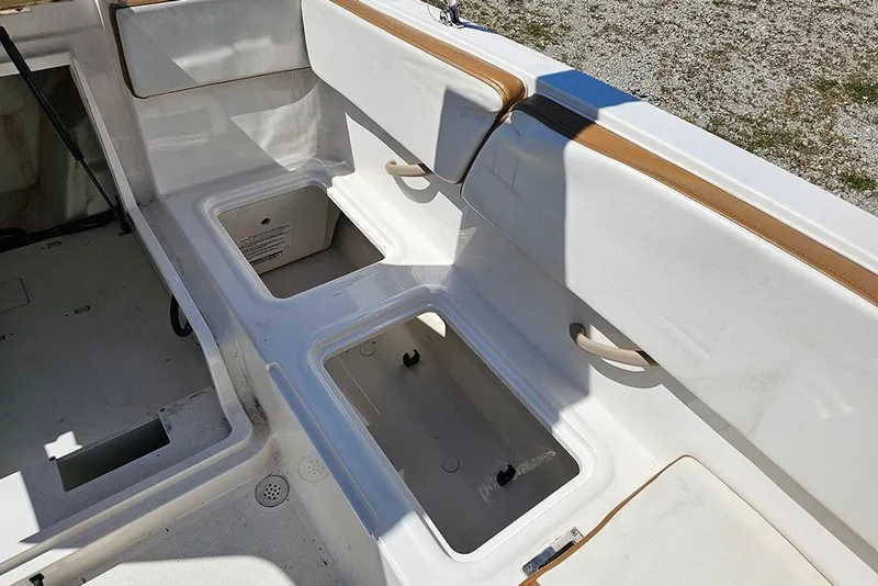 Slide: The Image of 2021 Bayliner VR4 Bowrider OB interior with storage compartments and seating. - 12