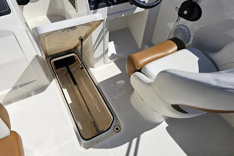 Slide: The Image of 2021 Bayliner VR4 Bowrider OB interior with open storage compartment and cushioned seating. - 15