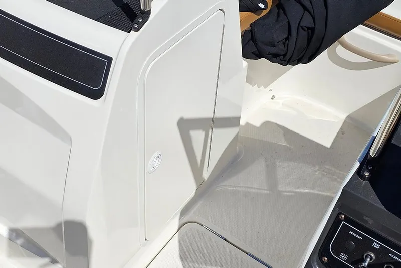 Slide: The Image of 2021 Bayliner VR4 Bowrider OB interior detail with storage compartment and control panel. - 17
