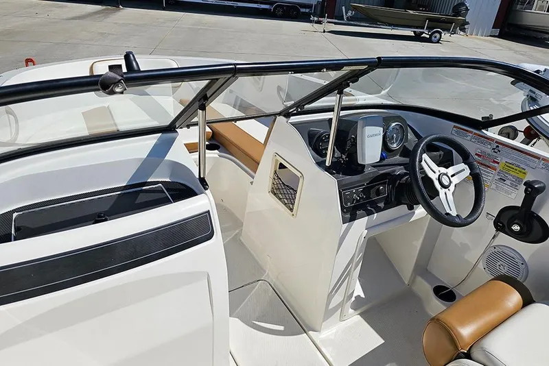 Slide: The Image of 2021 Bayliner VR4 Bowrider OB interior with steering wheel and dashboard controls. - 21