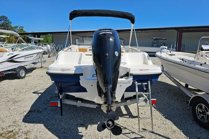Slide: The Image of 2021 Bayliner VR4 Bowrider OB with outboard motor, parked on gravel lot. - 8