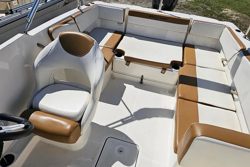 Slide: The Image of 2021 Bayliner VR4 Bowrider OB interior with tan and white seating arrangement. - 9