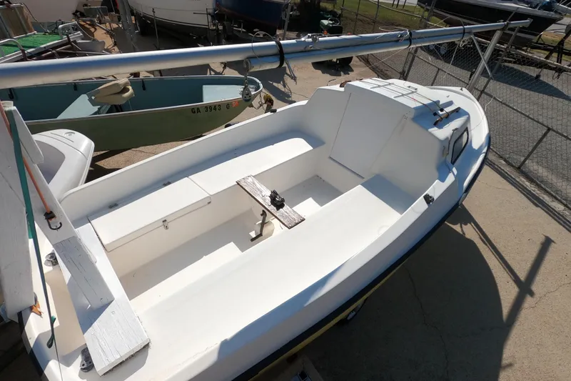 Slide: The Image of 1978 Newport 16 sailboat on trailer, white hull, docked in a boatyard. - 2