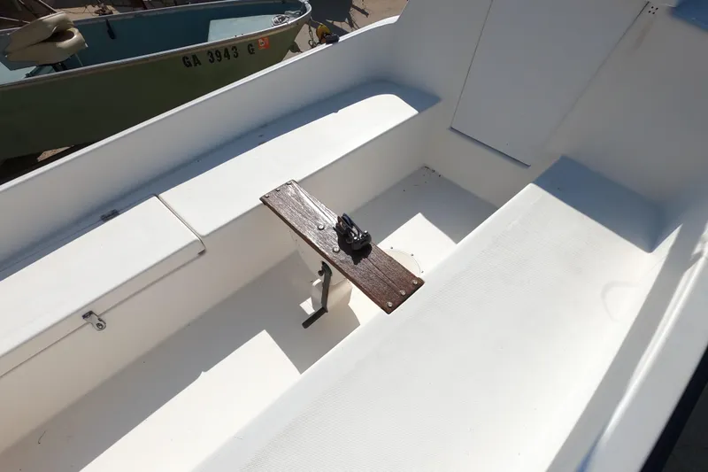 Slide: The Image of 1978 Newport 16 boat interior with white seating and wooden fixture. - 3