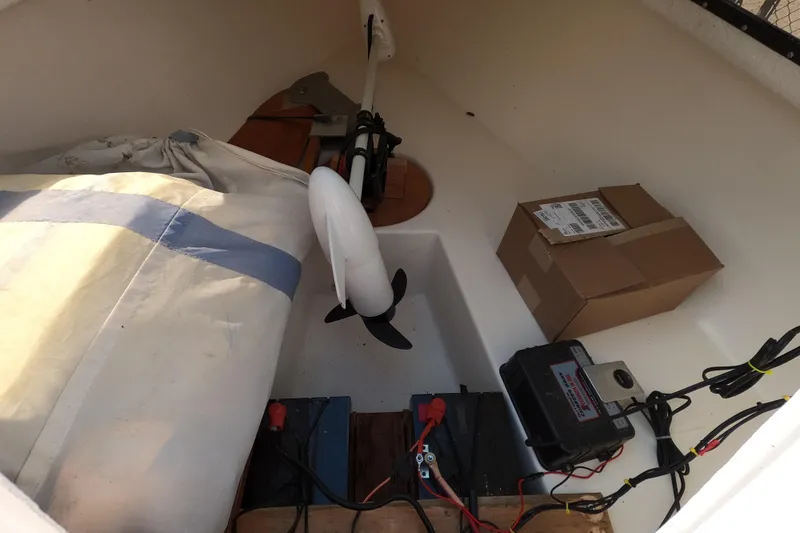 Slide: The Image of Interior of a 1978 Newport 16 sailboat with equipment and storage items. - 5