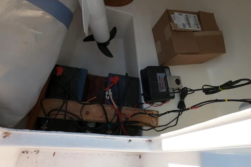 Slide: The Image of Electrical setup inside a 1978 Newport 16 boat, featuring batteries and wiring. - 6