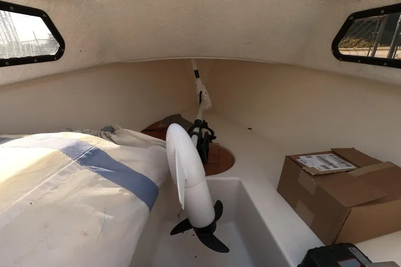 Slide: The Image of Interior of a 1978 Newport 16 sailboat with sail and boxes. - 7