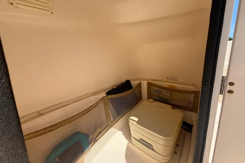 Slide: The Image of Interior cabin of 2005 Grady-White Tournament 225 boat with storage and portable toilet. - 7