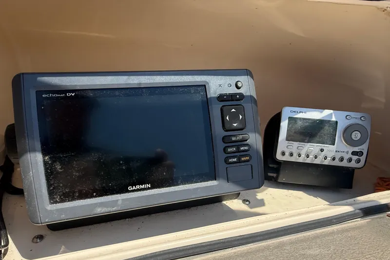 Slide: The Image of Garmin and Delphi devices on 2005 Grady-White Tournament 225 boat dashboard. - 9