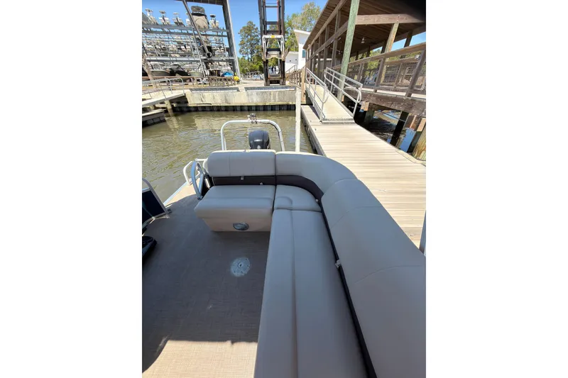 Slide: The Image of 2019 SUNTRACKER Party Barge 20 DLX at dock with comfortable seating. - 11