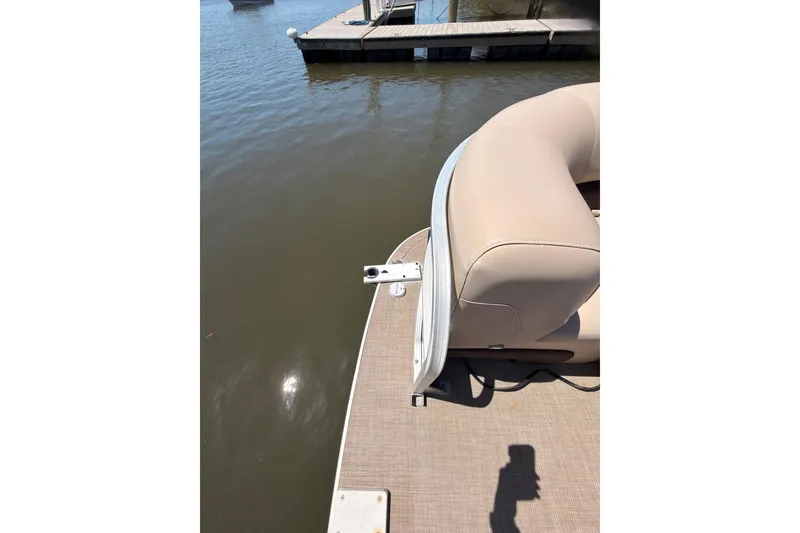 Slide: The Image of 2019 SUNTRACKER Party Barge 20 DLX pontoon boat docked by the water. - 15