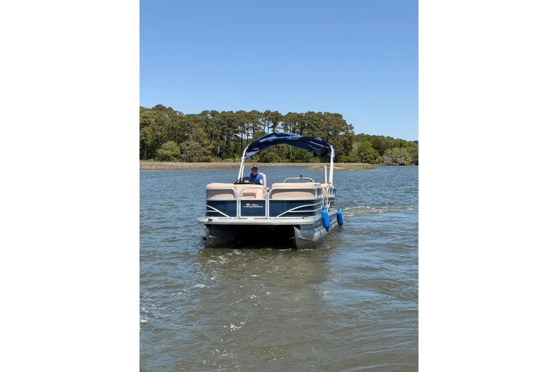 Slide: The Image of 2019 SUNTRACKER Party Barge 20 DLX pontoon boat cruising on a scenic lake. - 5