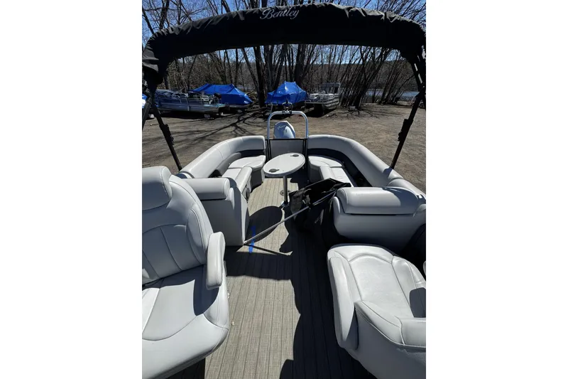 Slide: The Image of 2021 Bentley Pontoons Legacy 243 DL Navigator interior with plush seating and canopy. - 10