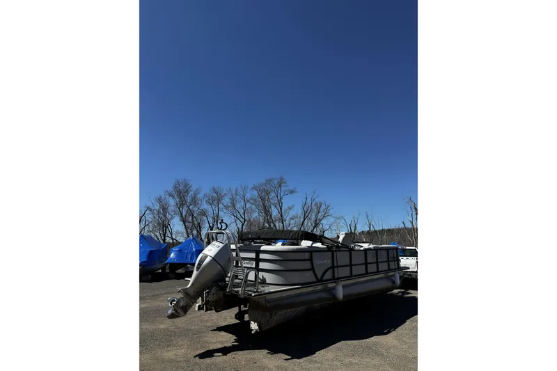 Slide: The Image of 2021 Bentley Pontoons Legacy 243 DL Navigator under clear blue sky. - 4