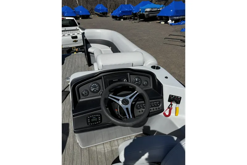 Slide: The Image of 2021 Bentley Pontoons Legacy 243 DL Navigator dashboard and seating area. - 6