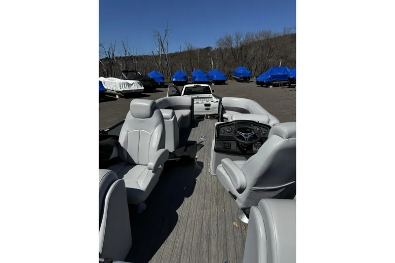 Slide: The Image of 2021 Bentley Pontoons Legacy 243 DL Navigator interior with gray seating and dashboard. - 7