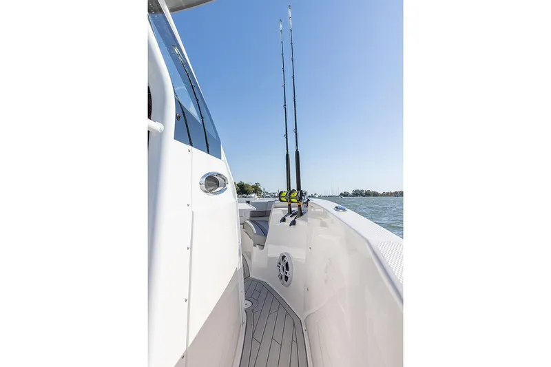 Slide: The Image of Manufacturer Provided Image: 2025 Solara S-250 CW boat deck with fishing rods under clear blue sky. - 14