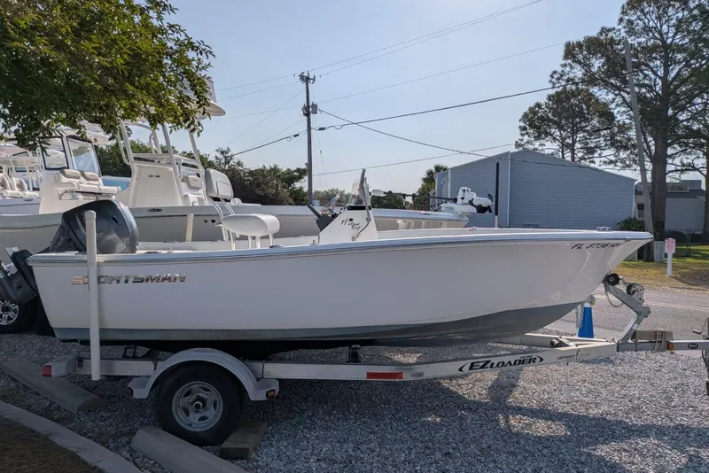 The Image of 2016 Sportsman Island Reef 17 Center Console boat on trailer in outdoor setting. - 1