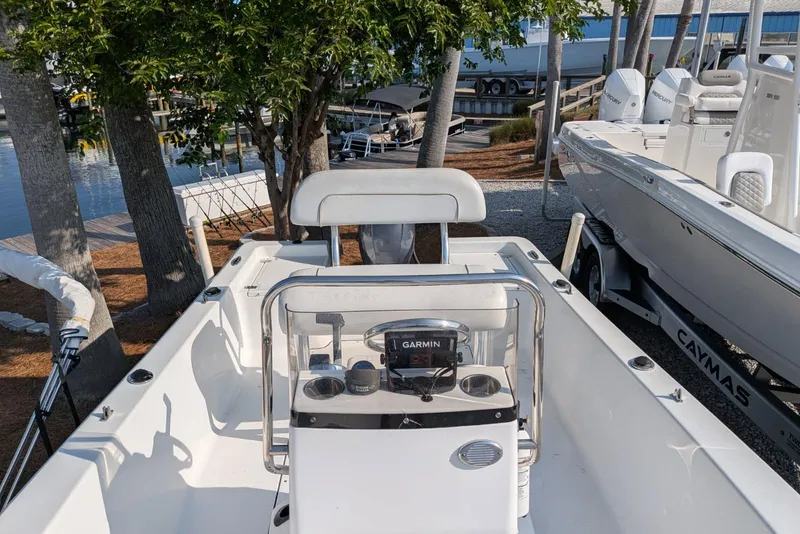 Slide: The Image of 2016 Sportsman Island Reef 17 Center Console boat docked near trees. - 5