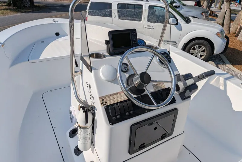 Slide: The Image of 2016 Sportsman Island Reef 17 Center Console boat with steering wheel and control panel. - 6