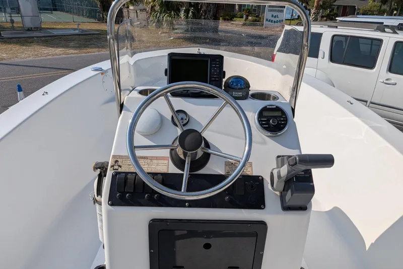 Slide: The Image of 2016 Sportsman Island Reef 17 Center Console boat dashboard with steering wheel and controls. - 7