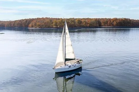 Slide: The Image of Beneteau Oceanis Clipper 343 sailing on calm lake, autumn landscape in background. - 7