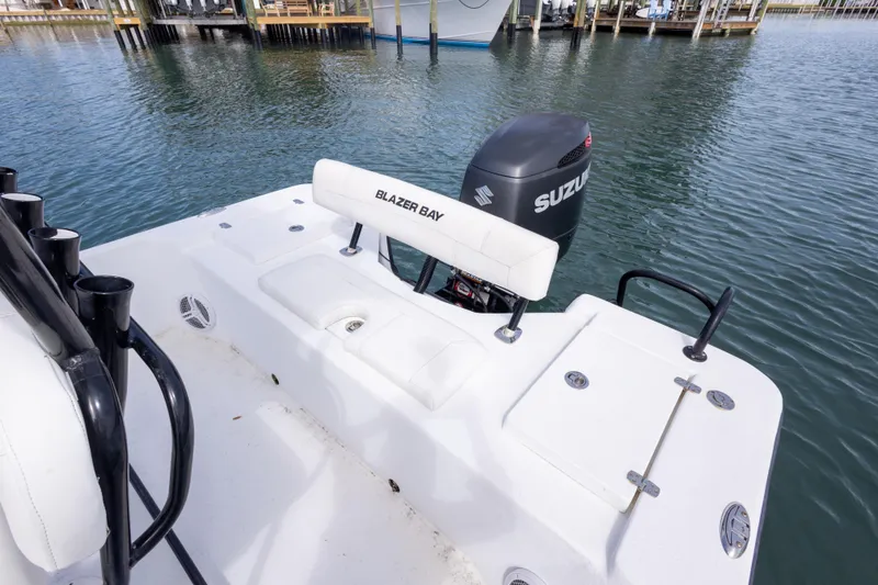 Slide: The Image of 2019 Blazer Bay 2400 boat with Suzuki outboard motor on calm water. - 12