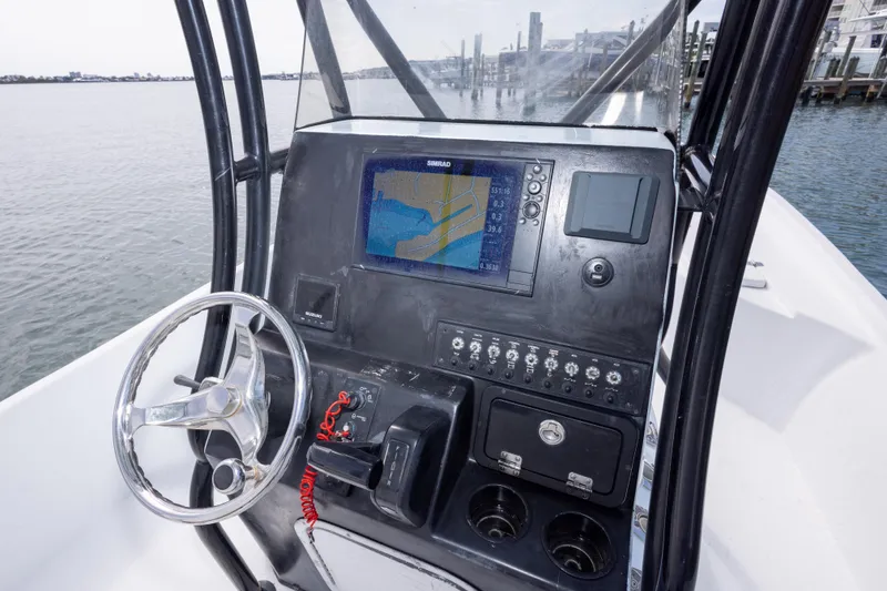 Slide: The Image of 2019 Blazer Bay 2400 boat dashboard with navigation system and steering wheel. - 15