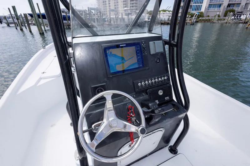 Slide: The Image of 2019 Blazer Bay 2400 boat console with steering wheel and navigation display. - 16