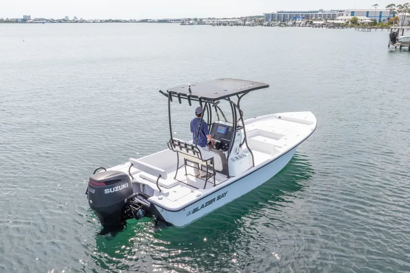 Slide: The Image of 2019 Blazer Bay 2400 boat with Suzuki outboard motor on calm water. - 31