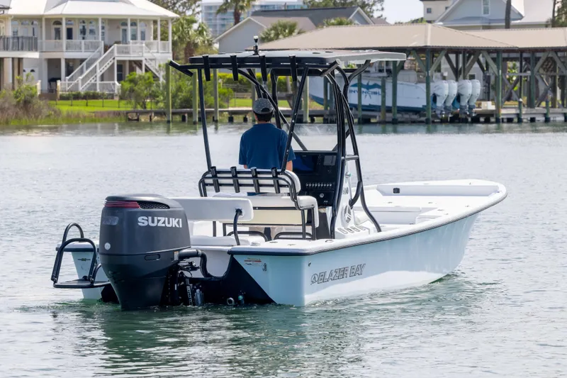Slide: The Image of 2019 Blazer Bay 2400 boat with Suzuki engine cruising on calm waters. - 5