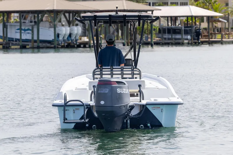 Slide: The Image of 2019 Blazer Bay 2400 boat with Suzuki outboard motor on calm water. - 6