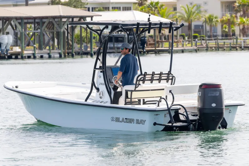 Slide: The Image of 2019 Blazer Bay 2400 boat on water, featuring Suzuki outboard motor. - 7