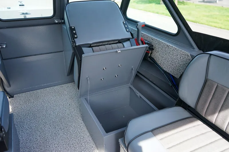 Slide: The Image of 2026 Alumaweld Talon 18 interior with open storage compartment and seating. - 10