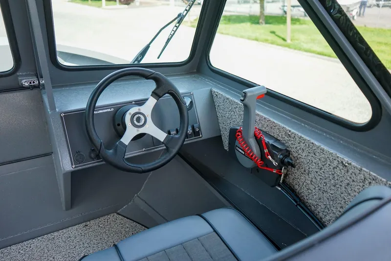 Slide: The Image of Interior of 2026 Alumaweld Talon 18 boat, featuring steering wheel and control panel. - 11