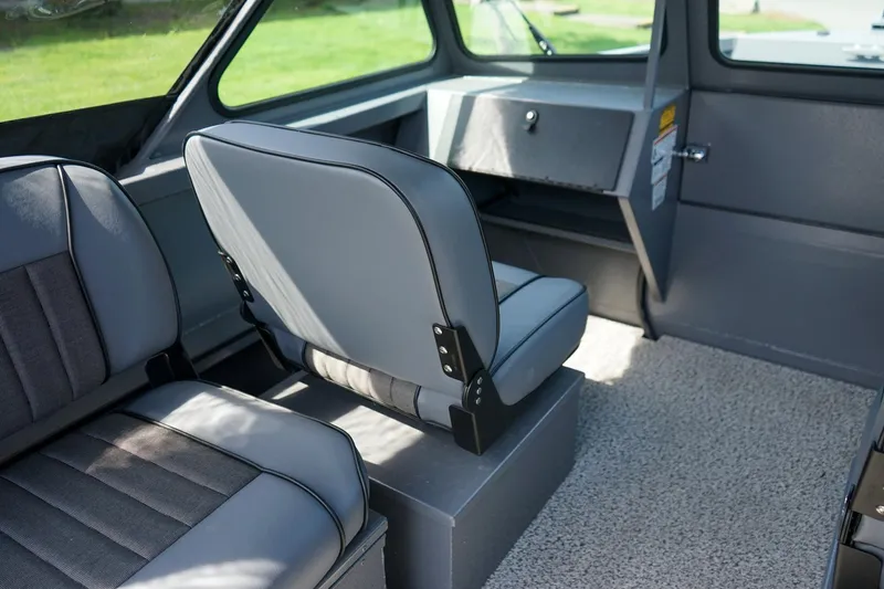 Slide: The Image of Interior of 2026 Alumaweld Talon 18 boat, featuring gray seating and carpeted flooring. - 12