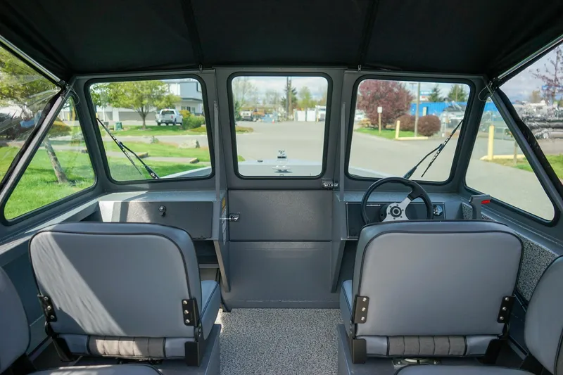 Slide: The Image of Interior view of 2026 Alumaweld Talon 18 boat, featuring dual seats and steering console. - 14