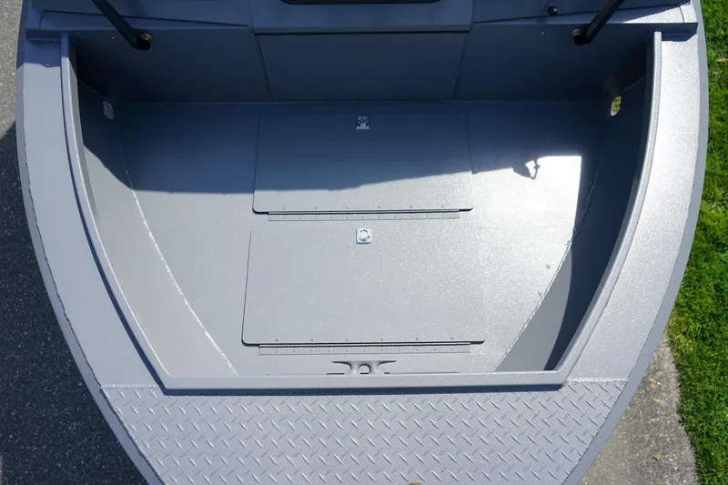 Slide: The Image of 2026 Alumaweld Talon 18 boat interior, featuring a spacious, gray deck with storage compartments. - 15