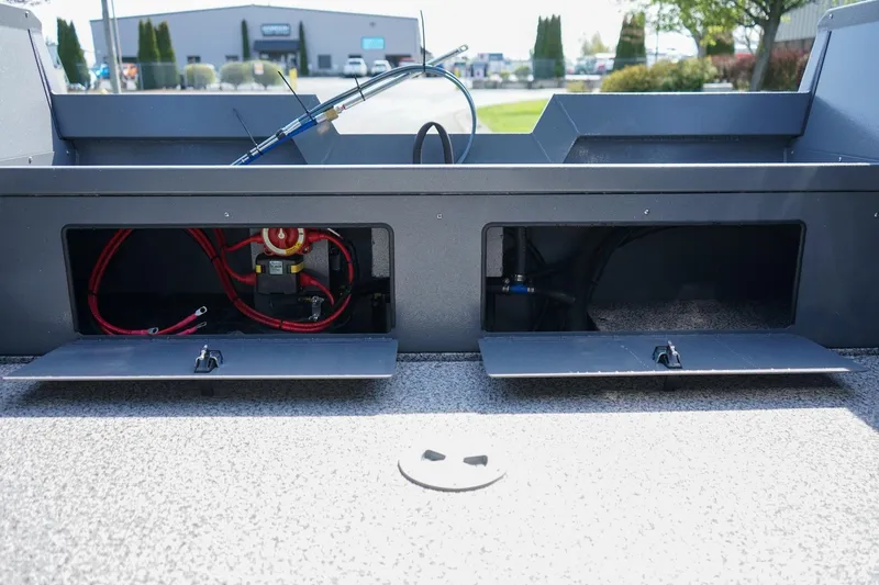 Slide: The Image of 2026 Alumaweld Talon 18 boat storage compartments with visible wiring and equipment. - 6