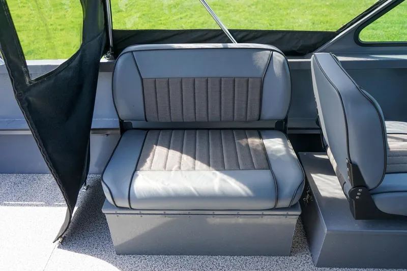 Slide: The Image of Interior seating of 2026 Alumaweld Talon 18 boat, featuring gray cushioned seats. - 7