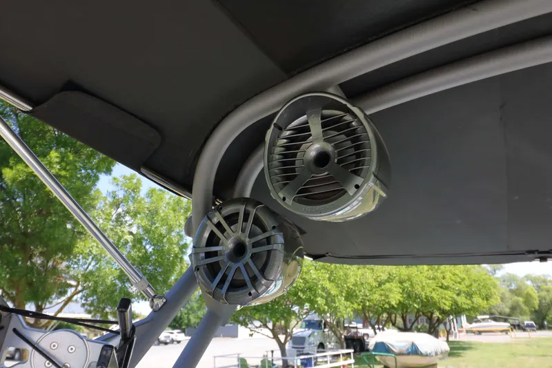 Slide: The Image of 2018 Sanger 212 SL boat dashboard with steering wheel and control panel. - 10