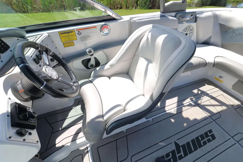Slide: The Image of Interior of a 2018 Sanger 212 SL boat with sleek seating and cup holders. - 12
