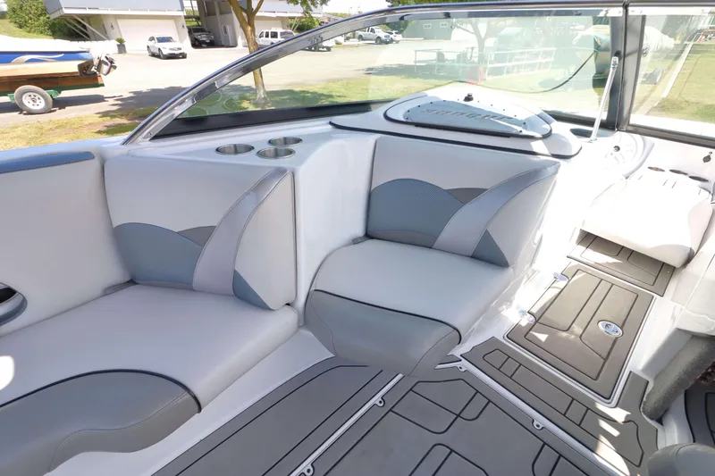 Slide: The Image of 2018 Sanger 212 SL boat interior with cushioned seating and speakers. - 13