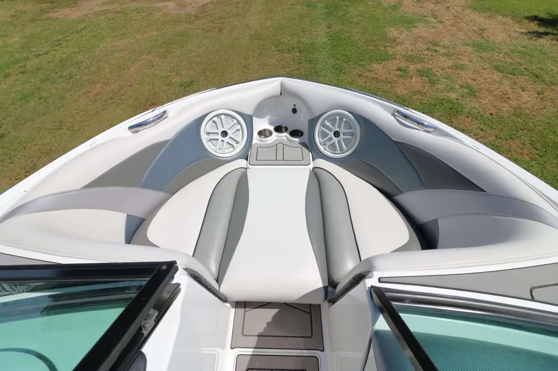Slide: The Image of 2018 Sanger 212 SL boat interior with open windshield, gray seating, and deck view. - 14
