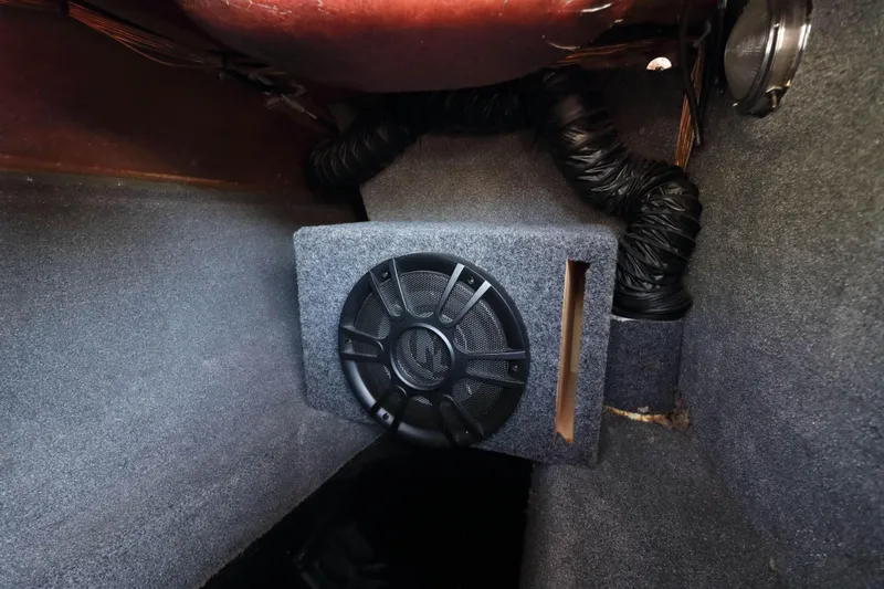 Slide: The Image of Audio equipment installation in a 2018 Sanger 212 SL boat, featuring amplifiers and wiring. - 18